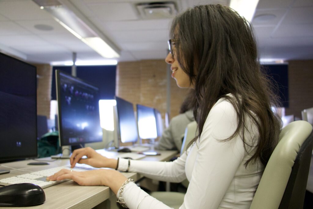 Student working at a workstation in the class of P220 for the Graphic & Web Design program.